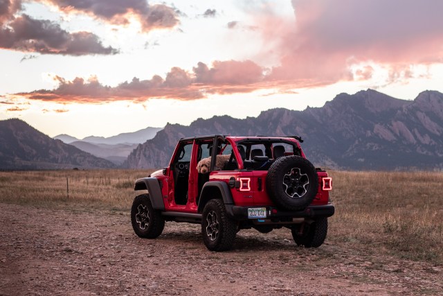 Jeep with sunset and mountains behind